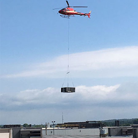 Helicopter lifting an AC system